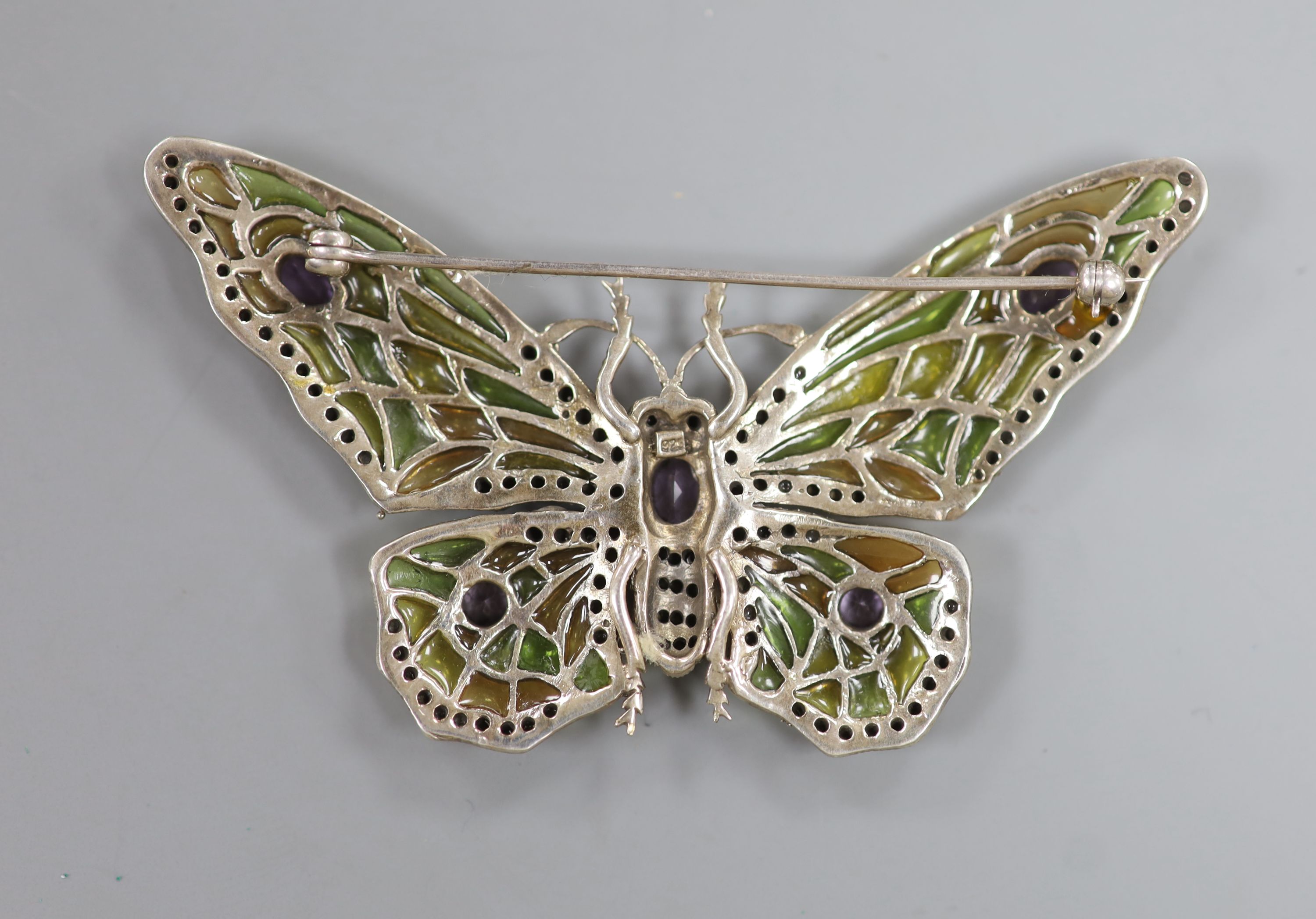 A 20th century 925 white metal, amethyst, marcasite and plique a jour set butterfly brooch